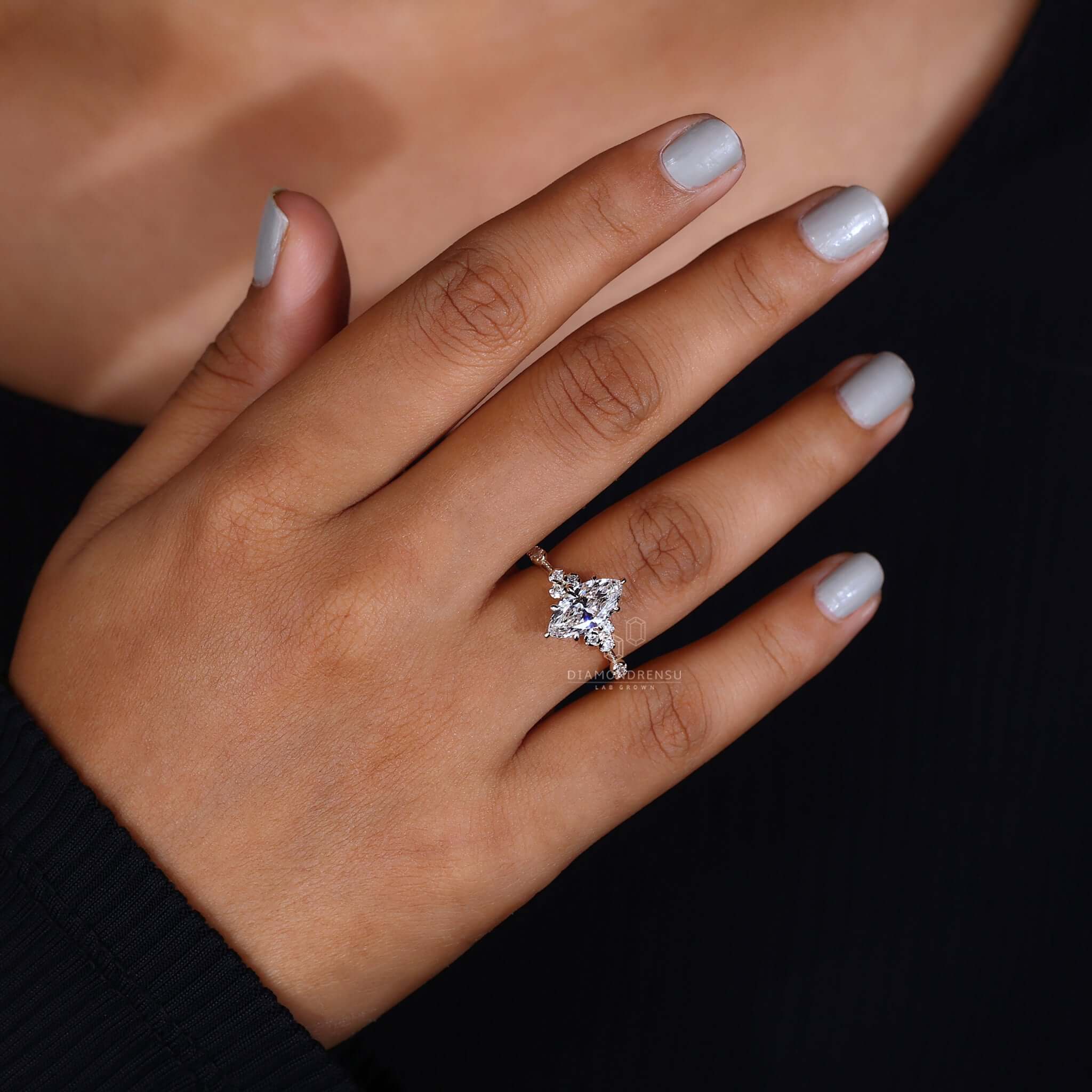 Stunning marquise diamond engagement ring on a hand, capturing the moment of a romantic proposal.