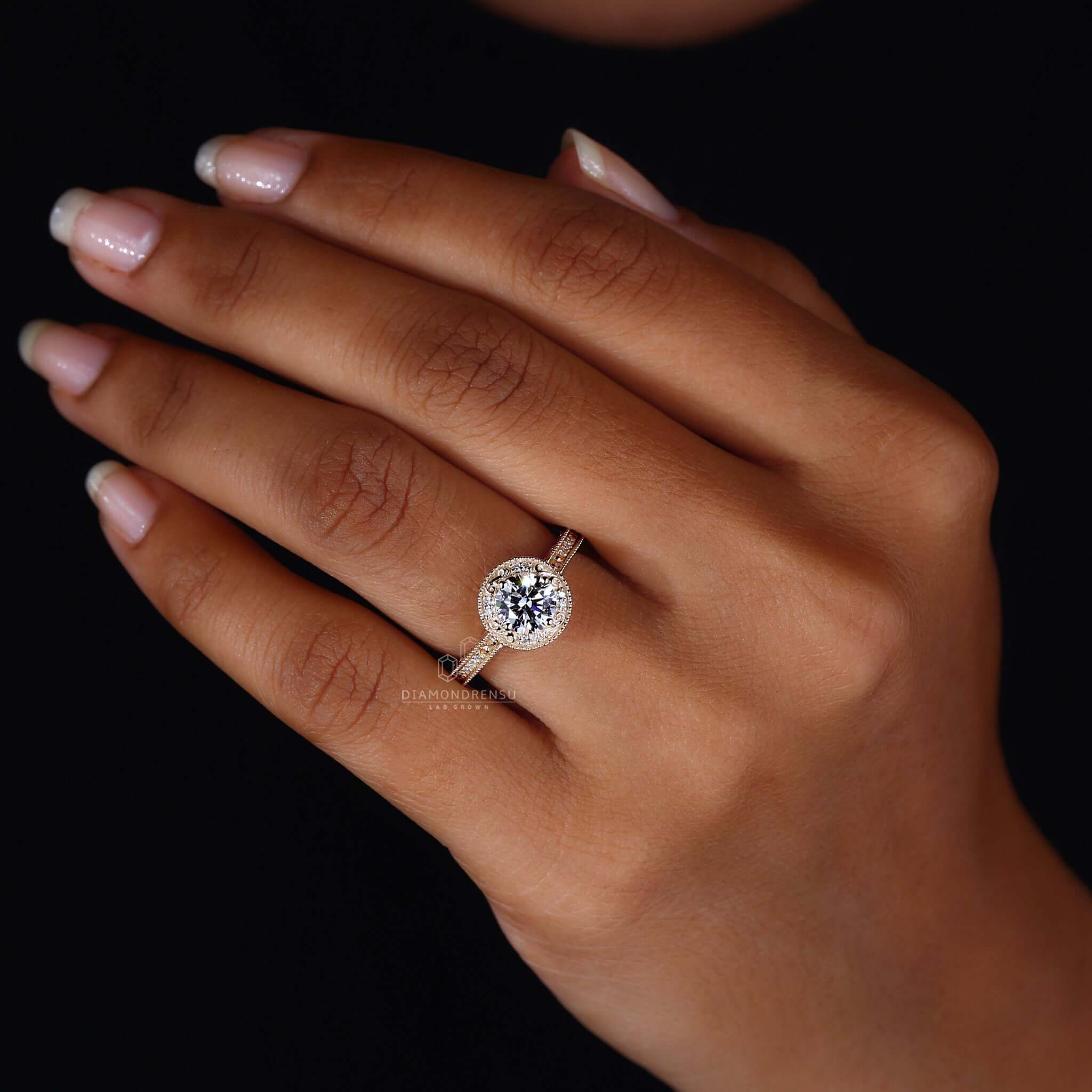 Hand wearing a round lab-grown diamond ring, emphasizing its ethical brilliance and modern design