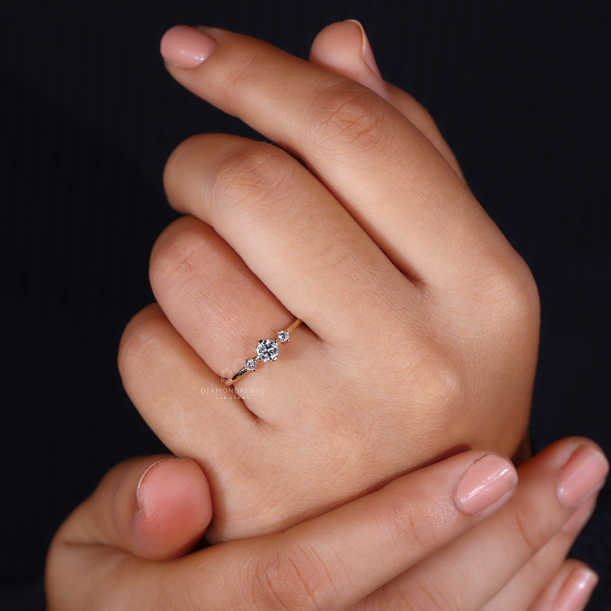 Handmade ring featuring a three stone round engagement style with Lab Grown Diamonds