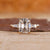 Old mine cushion cut diamond ring with tapered baguette side stones, offering a unique design.
