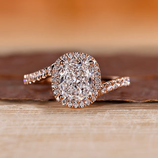 Cushion halo engagement ring in rose gold.

