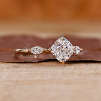 Cushion and marquise diamond ring in yellow gold.
