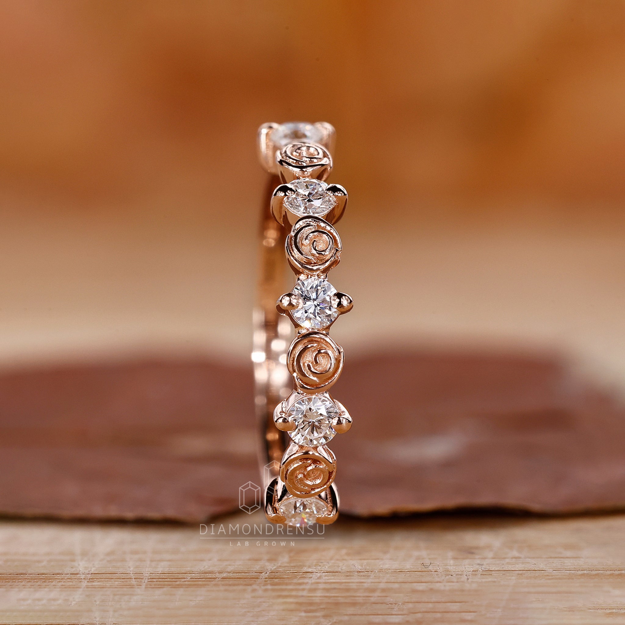 Elegant round cut diamond wedding band with nature-inspired elements.