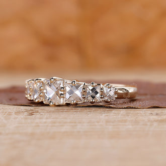Yellow gold wedding band with French cut diamonds and prong set.
