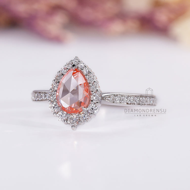 Halo setting pear cut diamond engagement ring.