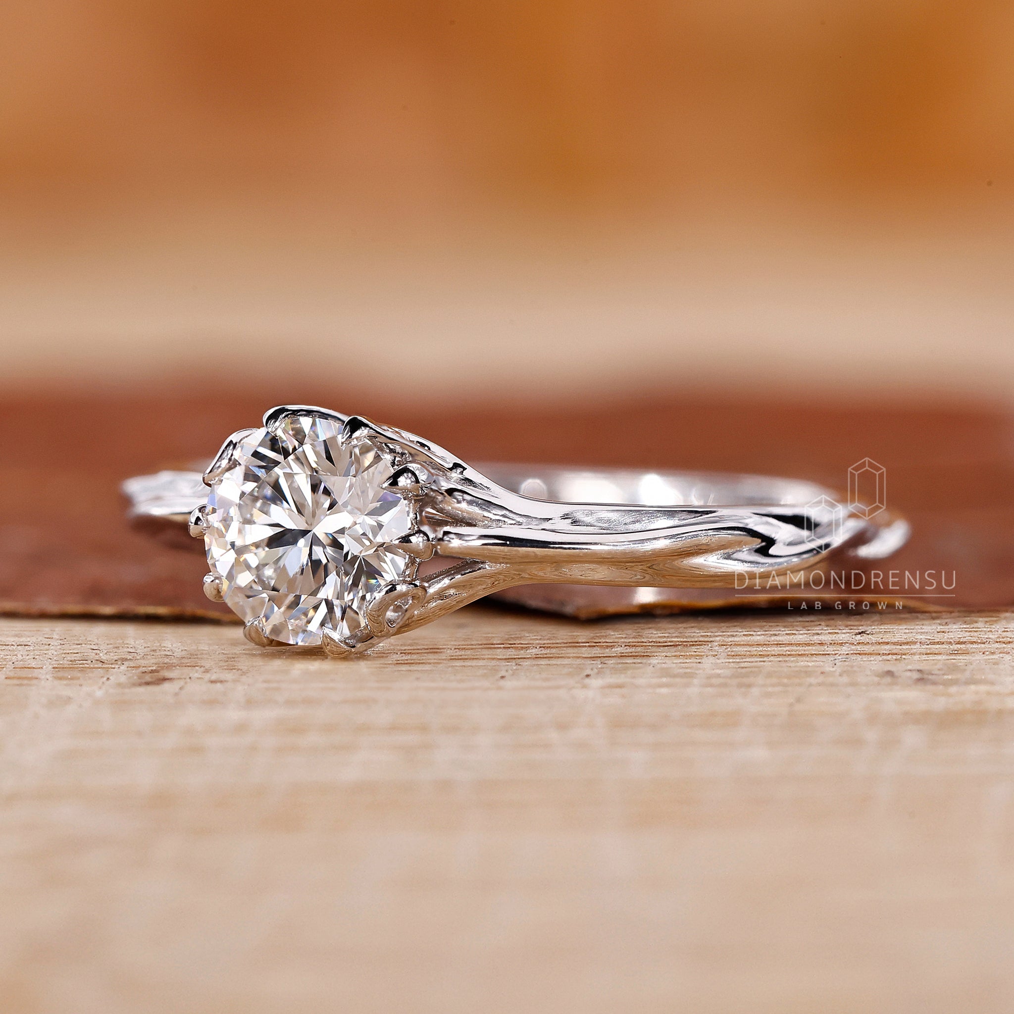 Stunning diamondrensu nature inspired engagement ring with a round solitaire diamond and nature-themed design