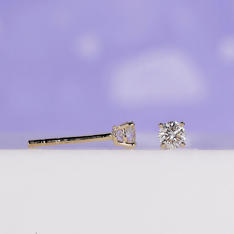 Gold diamond earrings with a sleek and minimalistic design for a refined look.
