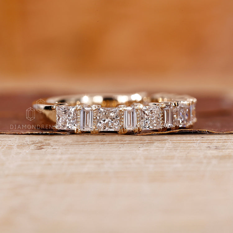 Handmade yellow gold band with princess and baguette diamonds.
