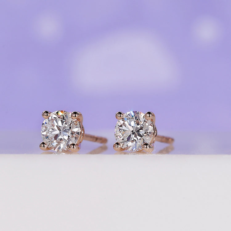 Sparkling round diamond earrings studs in a rose gold finish.
