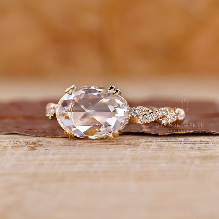 Oval ring with hidden halo, set in a double claw prong for added brilliance.
