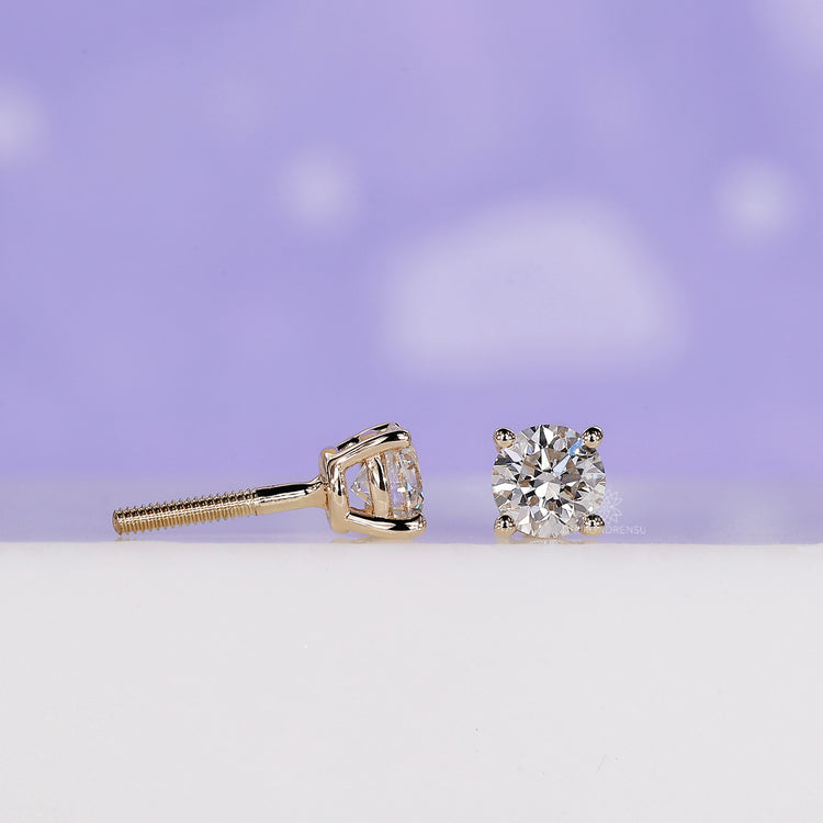Sparkling round cut diamond earrings with a modern design.