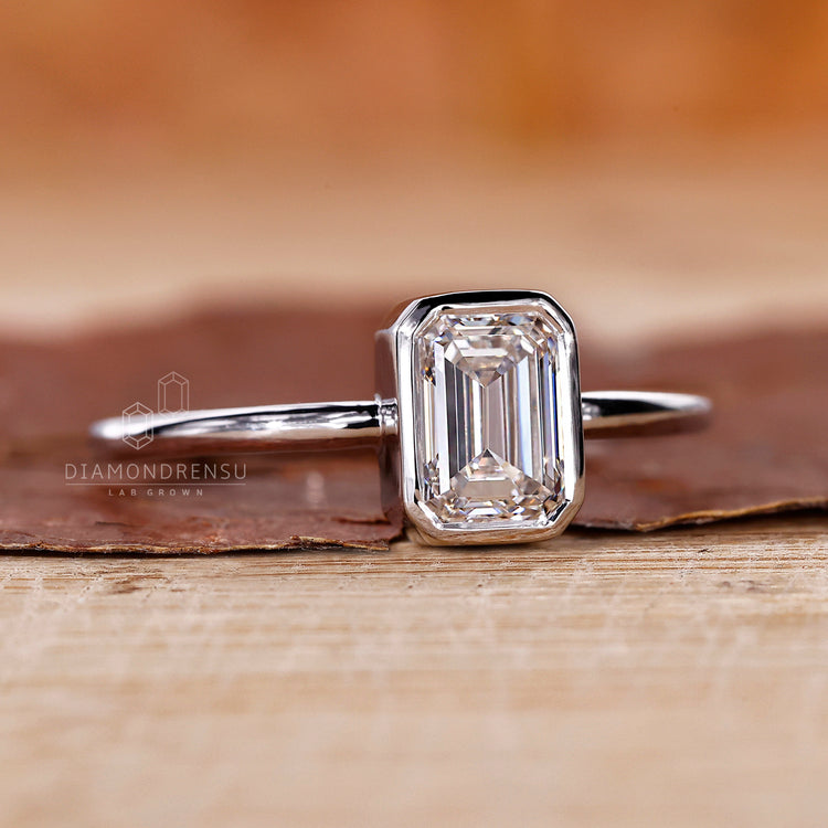 Solitaire Ring with a brilliant emerald cut diamond center.