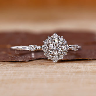 Halo engagement ring styled with round side stones.

