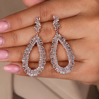 Prong set baguette and round diamond drop earrings
