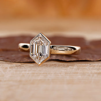 Hexagon cut engagement ring with a secure bezel set ring
