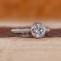 Two row pave band ring with round cut diamond and cathedral setting.
