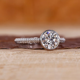 Two row pave band ring with round cut diamond and cathedral setting.
