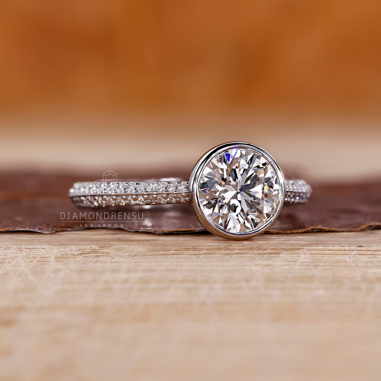 Two row pave band ring with round cut diamond and cathedral setting.
