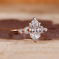 Muse setting marquise shaped diamond ring with marquise side stone.
