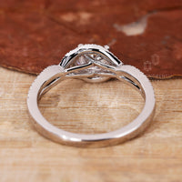 A delicate twisted halo ring crafted with precision and timeless charm.
