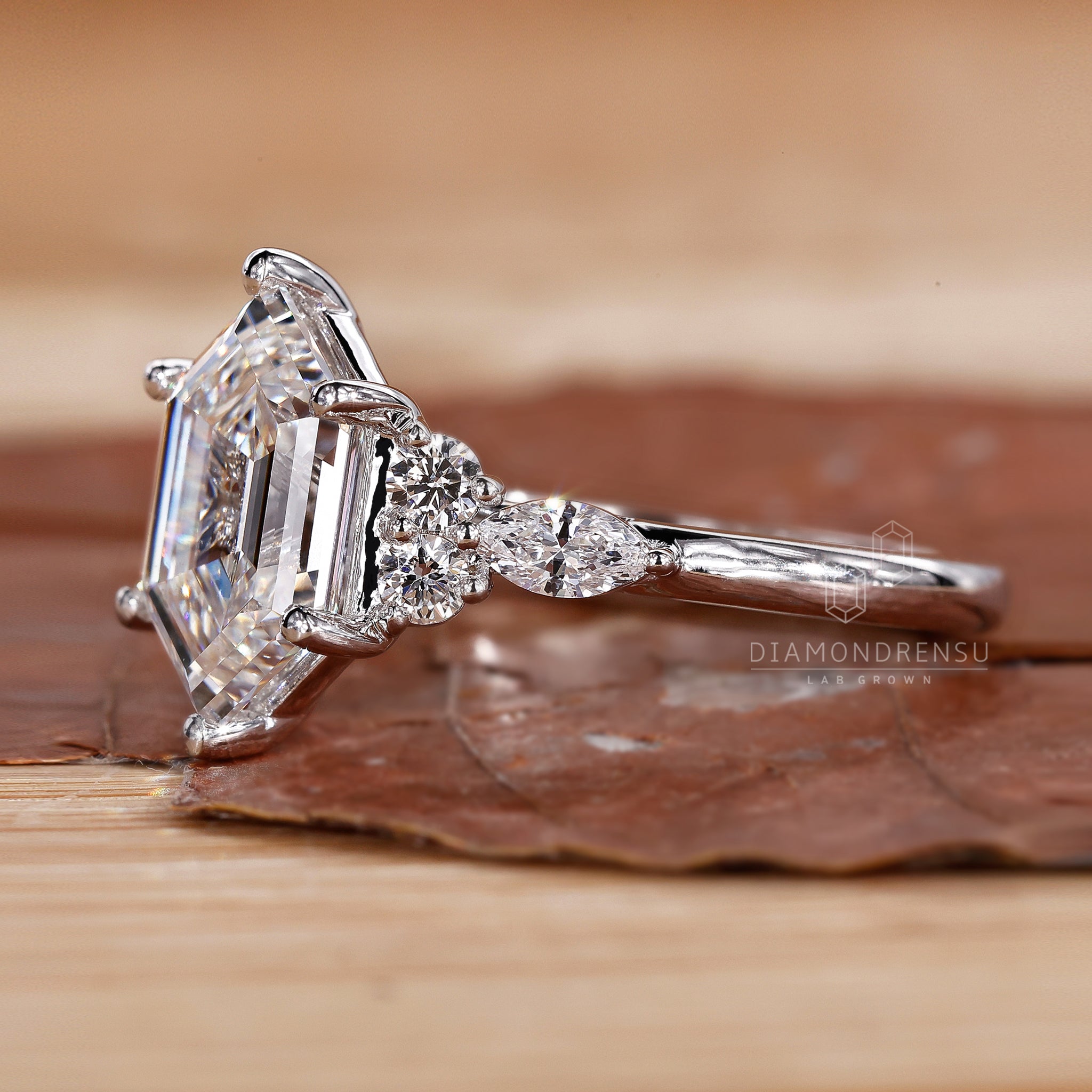 A stunning step-cut hexagon diamond, expertly crafted and nestled within a classic 6-prong engagement ring setting