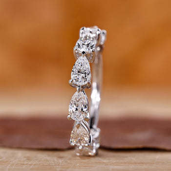 A pear-shaped wedding band with sparkling lab-grown diamonds.
