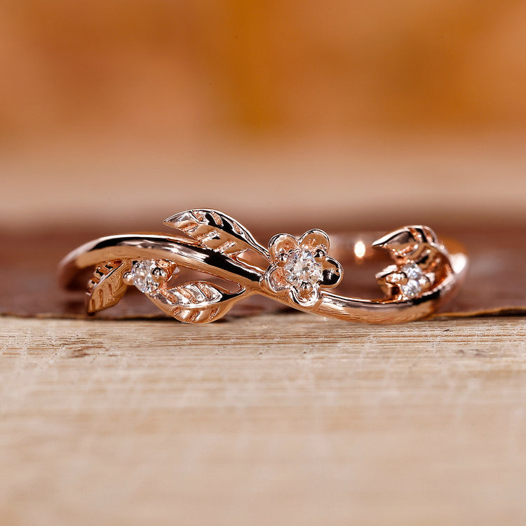 Leaf diamond wedding band in rose gold with round cut stones.
