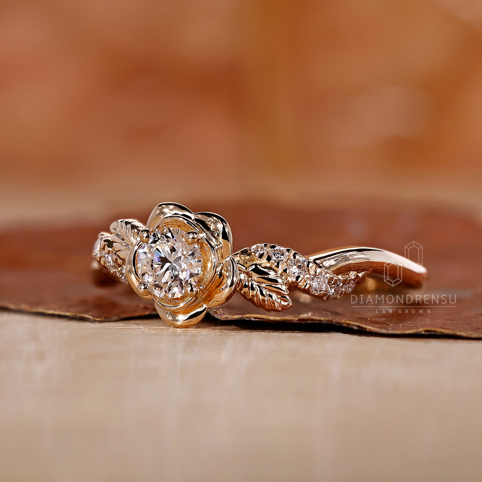 Floral engagement ring showcasing a lab-grown round diamond with intricate floral patterns