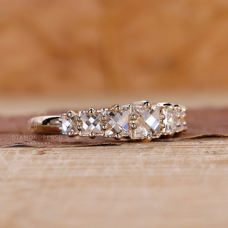 Handmade band with French cut diamonds in a yellow gold setting.
