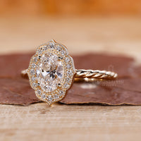 Round diamond halo ring in a delicate setting.
