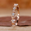 Nature-inspired diamond wedding band with intricate floral design and round cut diamond.