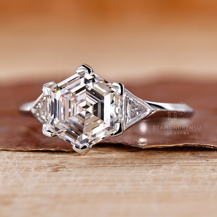 White gold ring with v shaped prong setting and hexagon diamond.
