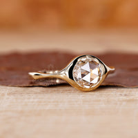 Custom engagement ring designed with a handcrafted bezel setting.
