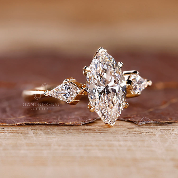 V shaped prong ring holding marquise diamond and side stones securely.
