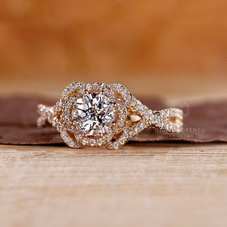 Lab-grown diamond halo engagement ring with twisted pave setting.
