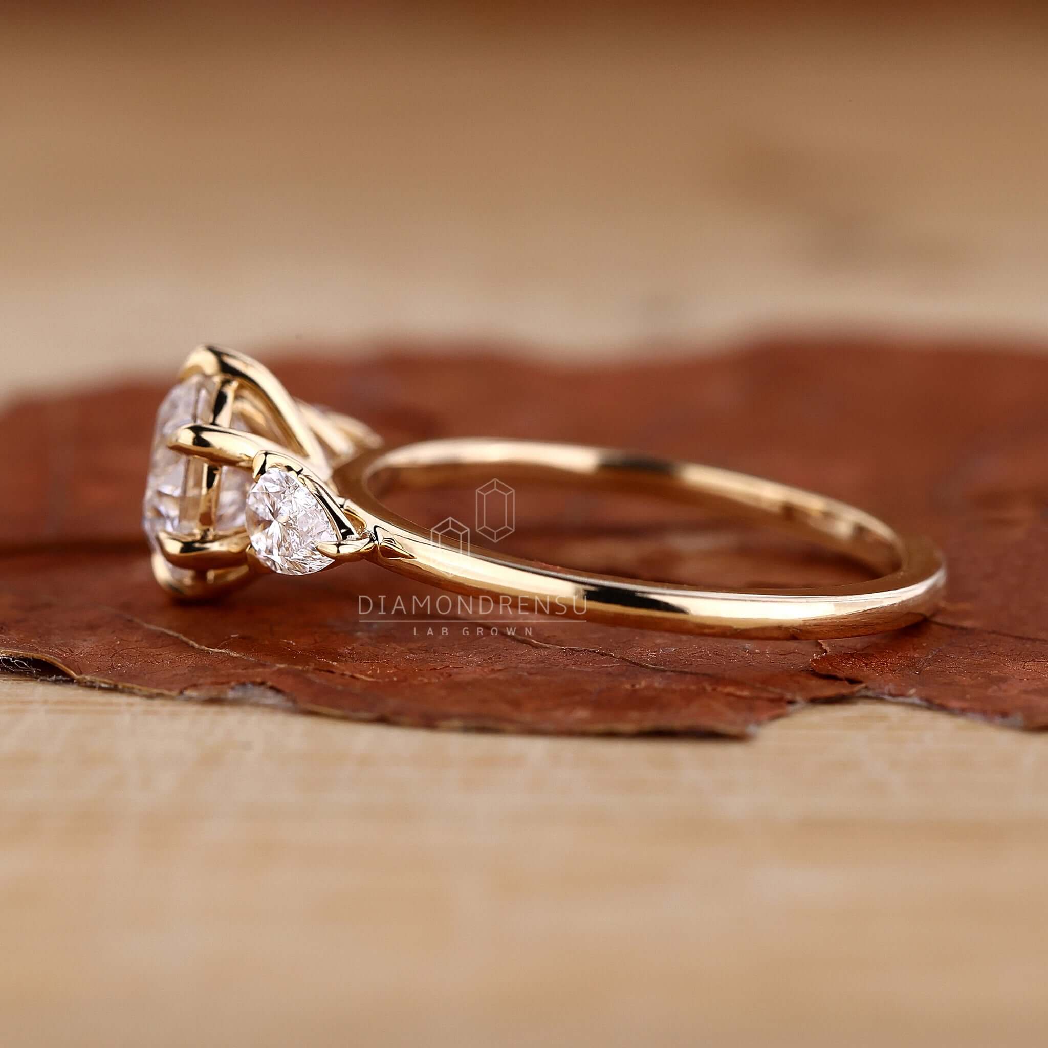 Classic three stone diamond ring in yellow gold, reflecting timeless beauty and sophistication.