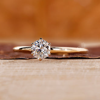 Yellow gold solitaire diamond ring featuring lab grown brilliant cut stone.
