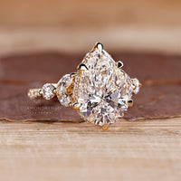 Tapered shank ring with pear cut diamond and tulip muse setting.
