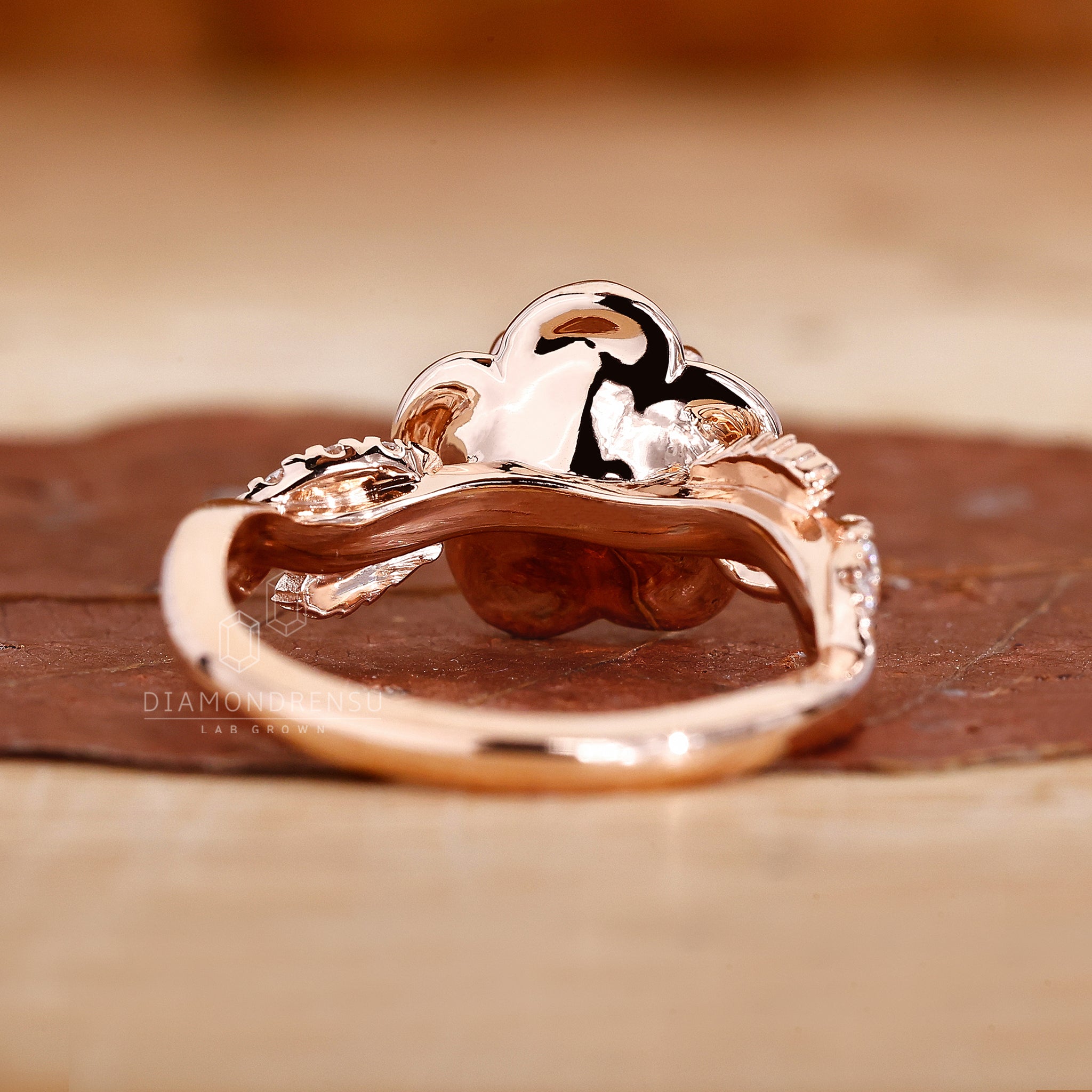 Twisted pave engagement ring featuring a round cut diamond set in rose gold, embodying nature inspired elegance.