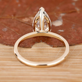 Custom engagement ring with a pear-shaped diamond, made to fit her style.

