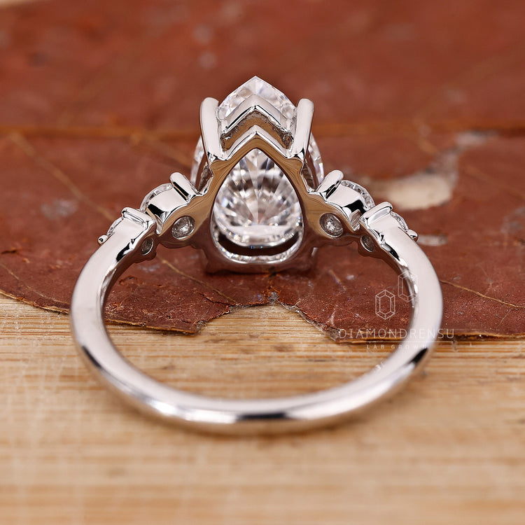 Handmade ring with pear and round diamonds.
