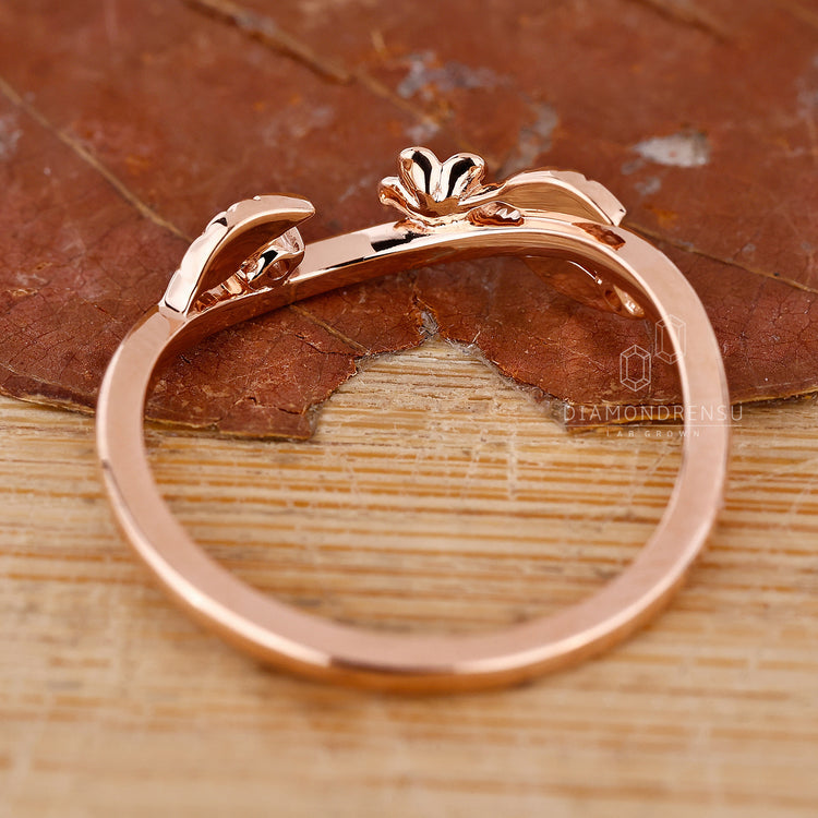 Custom handmade band with leaf and round diamond accents.
