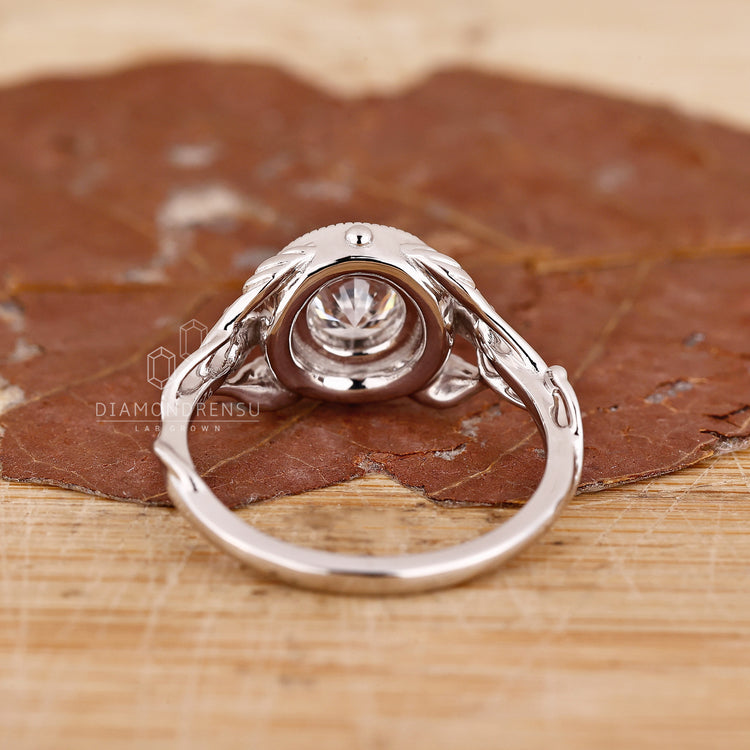 Buy engagement ring with a nature inspired design and a round halo ring style.
