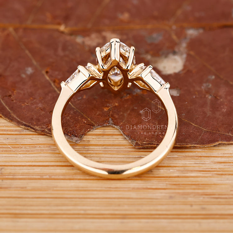 Lab Grown Diamond marquise diamond ring with claw prong and side stones.
