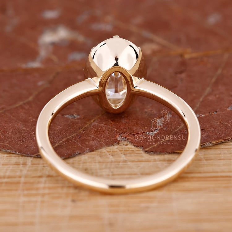 Lab-grown diamond ring with oval old European cut in claw prong setting.
