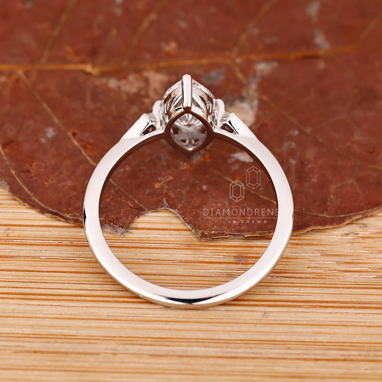 IGI certified marquise and round diamond engagement ring in white gold.
