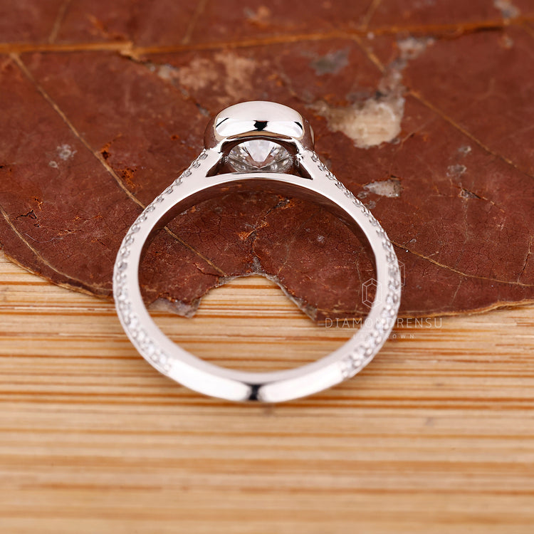Cathedral setting ring holding round cut diamond securely in place.
