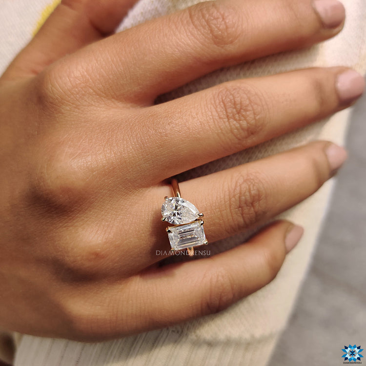 Emerald and pear cut 2 stone engagement ring.
