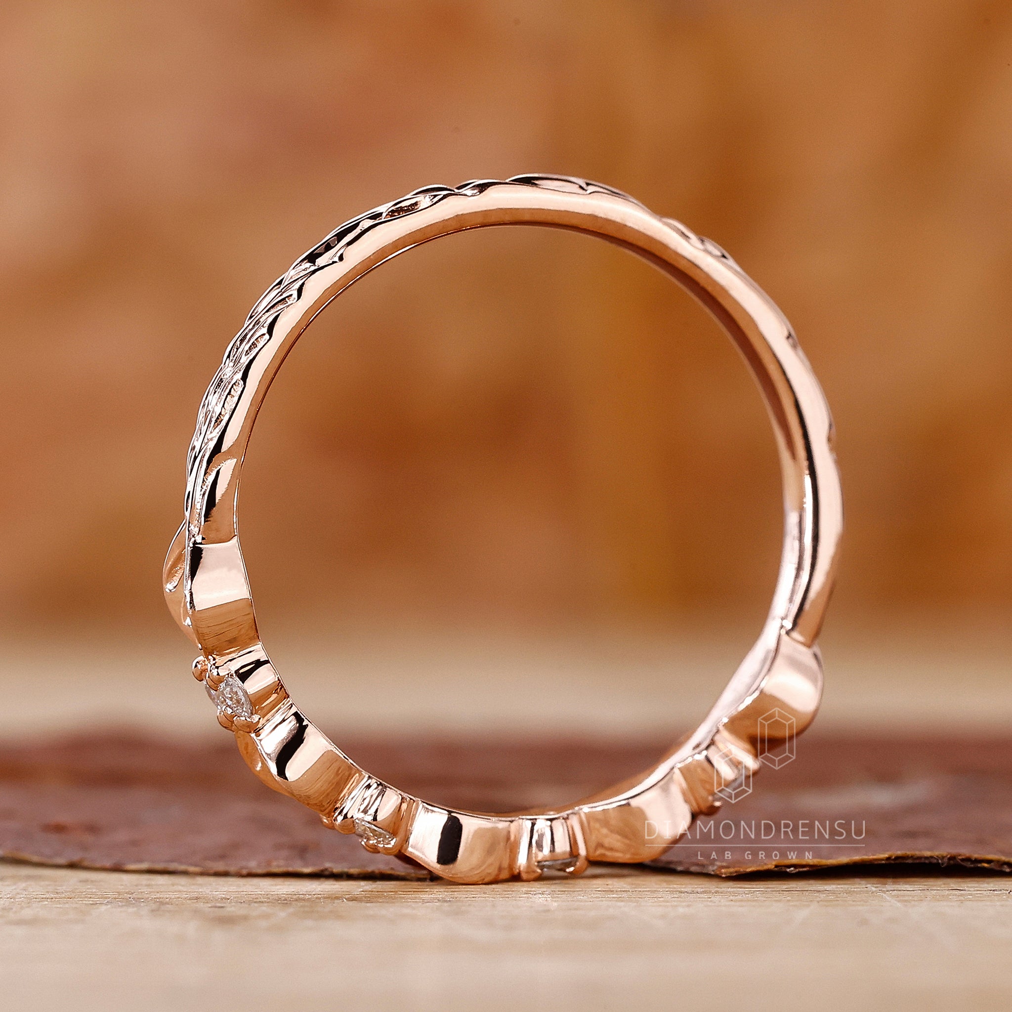 Beautiful gold leaf wedding band featuring a nature inspired design and round cut diamonds