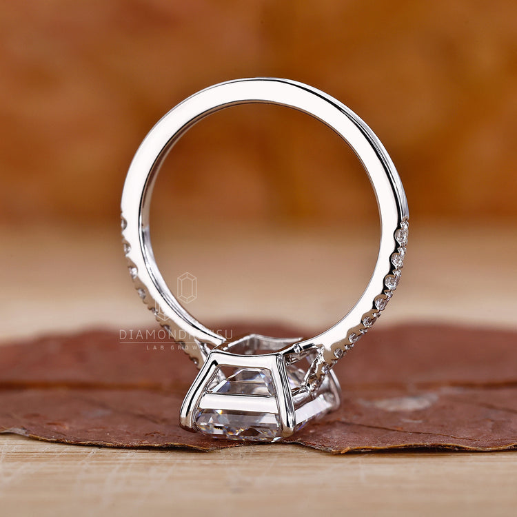 Claw Prongs on this Emerald White Gold Ring ensure diamond security.